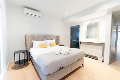 a bedroom with a bed with towels on it at Deluxe Downtown with spacious balcony in Nicosia