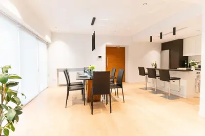 a dining room and kitchen with a table and chairs at Deluxe Downtown with spacious balcony in Nicosia