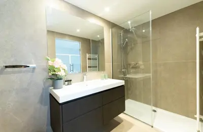 a bathroom with a sink and a shower at Deluxe Downtown with spacious balcony in Nicosia