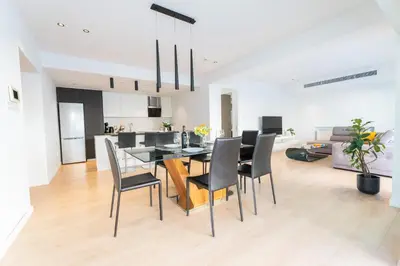 a kitchen and dining room with a table and chairs at Deluxe Downtown with spacious balcony in Nicosia
