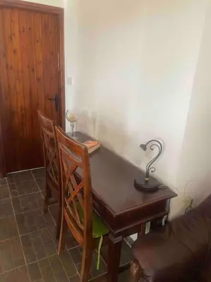 a desk with two chairs and a lamp on it at Mountain View! Cosy life in Nicosia