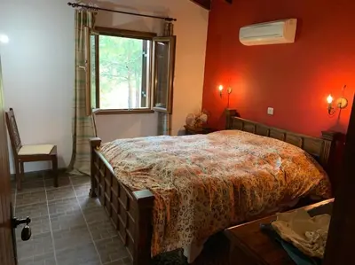 a bedroom with a large bed in a red wall at Mountain View! Cosy life in Nicosia