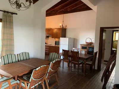 a kitchen and dining room with a wooden table and chairs at Mountain View! Cosy life in Nicosia