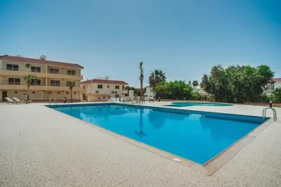 a large swimming pool in front of a building at Hana Nissi in Ayia Napa