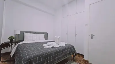 a white bedroom with a bed with towels on it at STAY City Life Apartment I in Nicosia