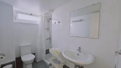 a white bathroom with a toilet and a sink at STAY City Life Apartment II in Nicosia