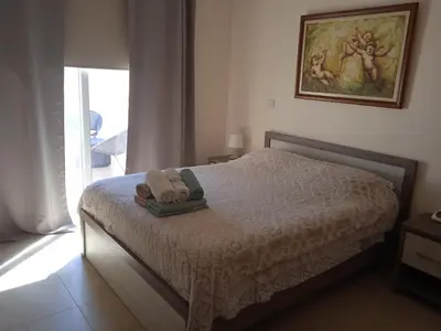 a bedroom with a bed with two towels on it at Xylophagou Rest and Relax 4 Top floor Big Balcony 1 bedroom apartment in Xylophaghou