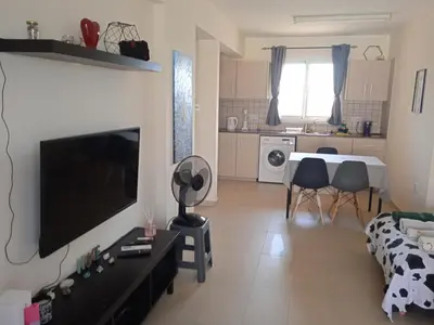 a living room with a flat screen tv on a wall at Xylophagou Rest and Relax 4 Top floor Big Balcony 1 bedroom apartment in Xylophaghou