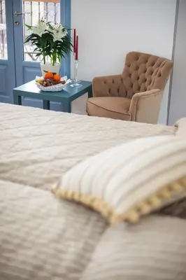 a bedroom with a bed and a table with a chair at Operetta House in Larnaka