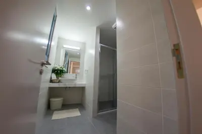 a bathroom with a shower and a sink and a mirror at Operetta House in Larnaka