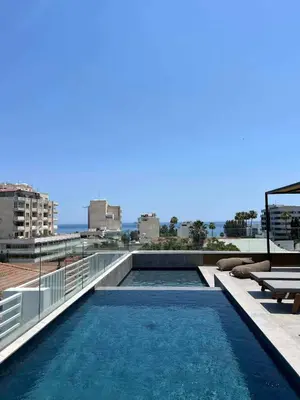 a swimming pool on the roof of a building at Alinea Diono Historic Center in Limassol