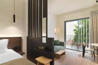 a bedroom with a bed and a couch and a balcony at Alinea Diono Historic Center in Limassol
