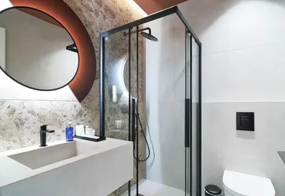 a bathroom with a shower and a sink and a mirror at Alinea Diono Historic Center in Limassol