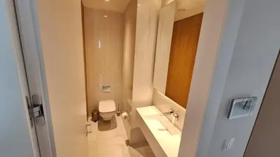 a white bathroom with a toilet and a sink at Del Mar 2 Bedroom Deluxe Seaside 'A' Residence in Limassol