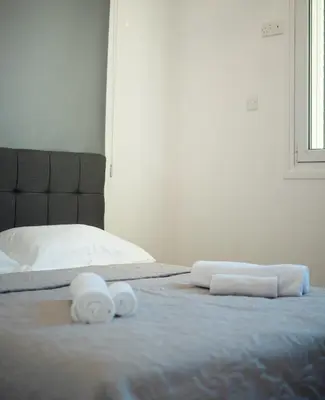 a bedroom with two towels on a bed at Maestro Sunrise View in Larnaka
