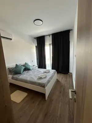 a bedroom with a bed with green pillows at Limassol Urban Beach Retreat- 500m from the beach in Limassol