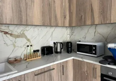 a kitchen counter with a microwave and a toaster oven at Limassol Urban Beach Retreat- 500m from the beach in Limassol