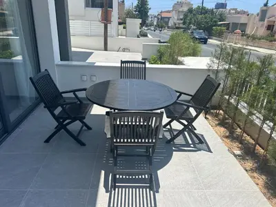 a table and chairs on a balcony with a table and chairs at Limassol Urban Beach Retreat- 500m from the beach in Limassol