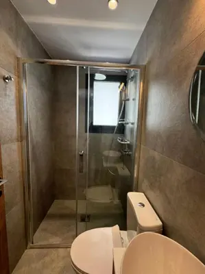 a bathroom with a shower and a toilet and a sink at Limassol Urban Beach Retreat- 500m from the beach in Limassol