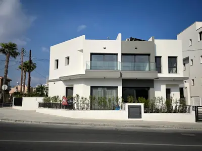 a white building on the side of a street at Limassol Urban Beach Retreat- 500m from the beach in Limassol