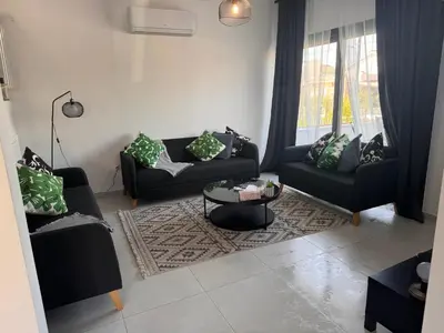 a living room with two couches and a table at Limassol Urban Beach Retreat- 500m from the beach in Limassol