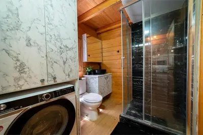 a bathroom with a toilet and a glass shower at Ktima To Alliotiko - Lofou 1 in Lofou