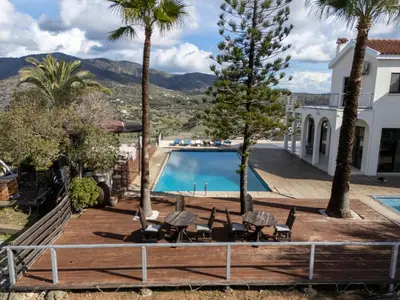 a villa with a swimming pool and palm trees at Great property - amazing views in Limassol