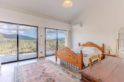 a bedroom with a bed and large windows at Great property - amazing views in Limassol