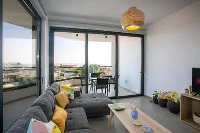 a living room with a couch and a table at Palmove Newly Build Seaview Apt in Larnaka