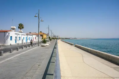 a sidewalk next to the water with buildings and a street at Palmove Newly Build Seaview Apt in Larnaka