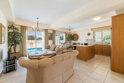 a living room with a couch and a kitchen at Villa Jacqueline in Protaras