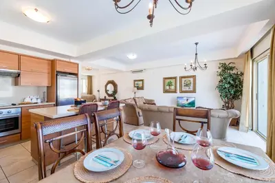 a kitchen and living room with a table and chairs at Villa Jacqueline in Protaras