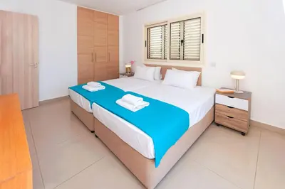 a bedroom with a large bed and a window at Villa Anemona - 100m from Pernera Beach in Protaras