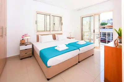 a bedroom with a large bed with towels on it at Villa Anemona - 100m from Pernera Beach in Protaras