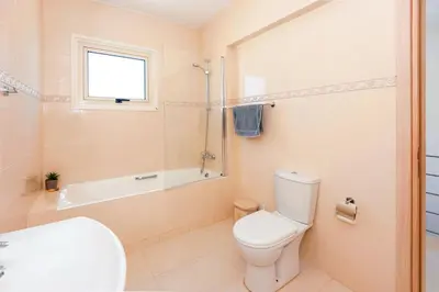 a bathroom with a toilet and a tub and a sink at Villa Anemona - 100m from Pernera Beach in Protaras