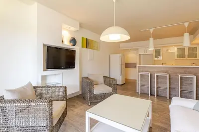 a living room with a couch and a table at Agia Napa three bedroom modern flat in Ayia Napa