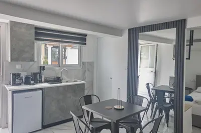 a kitchen and dining room with a table and chairs at Gold Emerging Villas Ltd Apart 1 in Ayia Napa