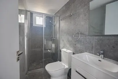 a bathroom with a toilet and a shower and a sink at Gold Emerging Villas Ltd Apart 1 in Ayia Napa