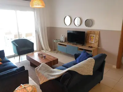 a living room with two couches and a television at Yippee! at Ermou Square Amazing Location View in Larnaka