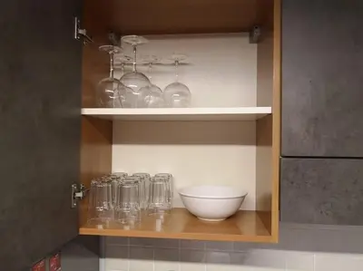 a shelf with glasses and a bowl in a kitchen at Yippee! at Ermou Square Amazing Location View in Larnaka