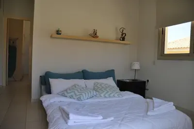 a bed with two pillows on it in a room at Ivory Suite at Polyxenia - Tourism licence 03125 in Protaras