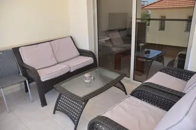 a living room with a couch and a table and chairs at Ivory Suite at Polyxenia - Tourism licence 03125 in Protaras