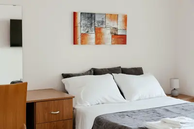 a bedroom with a bed and a painting on the wall at Leah's Deluxe Villa in Tersephanou