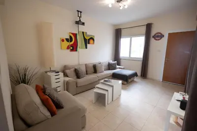 a living room with a couch and a table at Leah's Deluxe Villa in Tersephanou