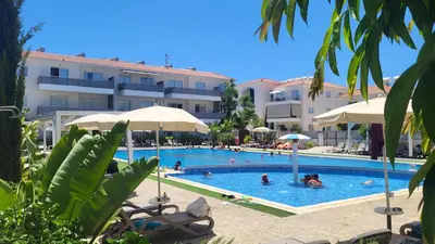 a swimming pool in front of a hotel at Mythical Sands resort - Hana in Paralimni