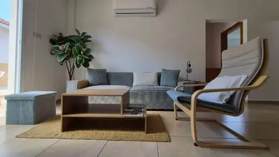 a living room with a couch and a coffee table at Mythical Sands resort - Hana in Paralimni