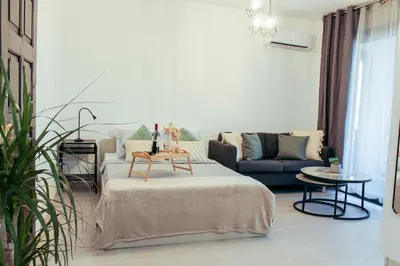 a living room with a bed and a couch at Cozy Studio Apt - Tourist Area Collection in Limassol