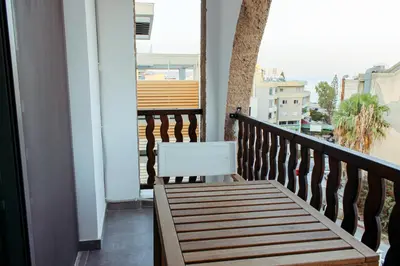a wooden bench sitting on a balcony with a view at Cozy Studio Apt - Tourist Area Collection in Limassol