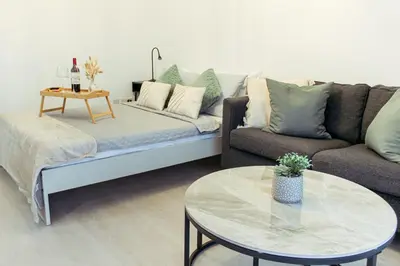 a living room with a couch and a table at Cozy Studio Apt - Tourist Area Collection in Limassol