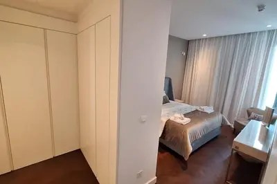 a bedroom with a bed and a chair and a window at Del Mar 2 Luxe Bedroom 'C' Highrise Residence in Limassol
